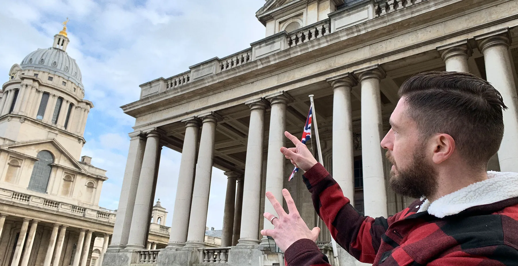 Pointing up at the columns of the Old Royal Naval College in Greenwich, for inspiration